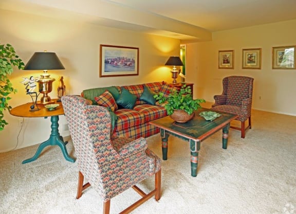 a living room with a couch and chairs and a table
