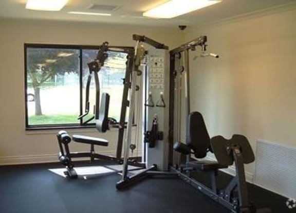 a gym with exercise equipment and a window