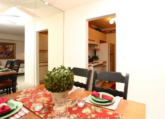 a dining room and kitchen with a table and chairs