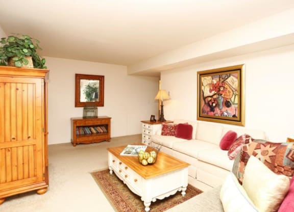 a living room with a white couch and a coffee table