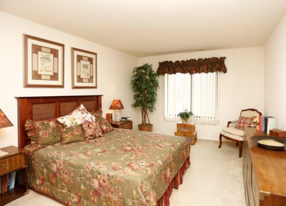 a bedroom with a bed and a dresser and a window