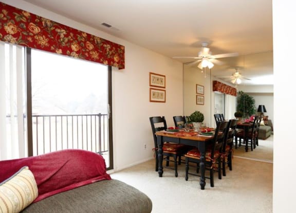a dining room and living room with a table and chairs