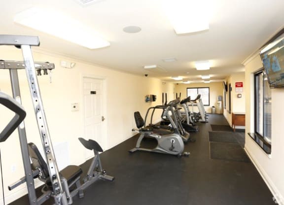 a gym with several pieces of exercise equipment on the floor