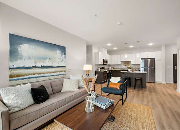 a living room with a couch and a table at The Landing at Amber Fields Apartments, Minnesota, 55068
