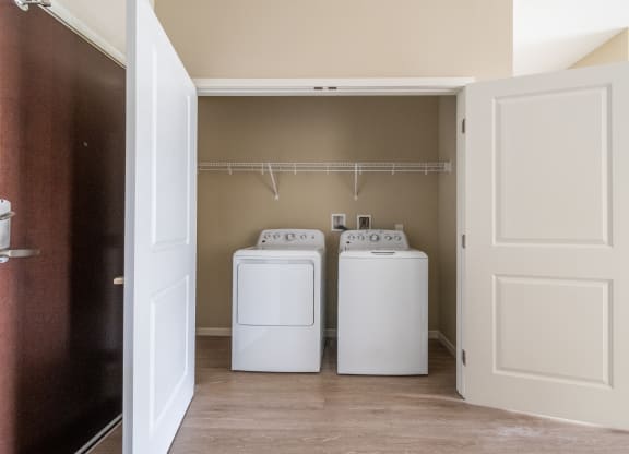 a washer and dryer in the laundry room of a manufactured home at The Winslow 62+ Apartments, West St Paul, MN