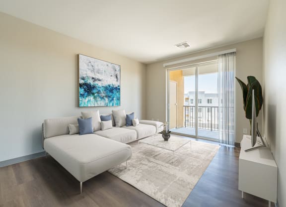 a living room with a white couch and a white rug