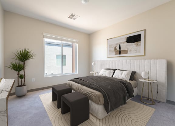 a bedroom with a large bed and two tables in front of a window