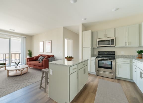 an open kitchen and living room with a couch and a table