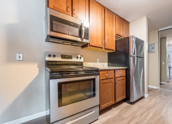 a kitchen with wooden cabinets at Heritage Hills Apartments, Bloomington, 55437