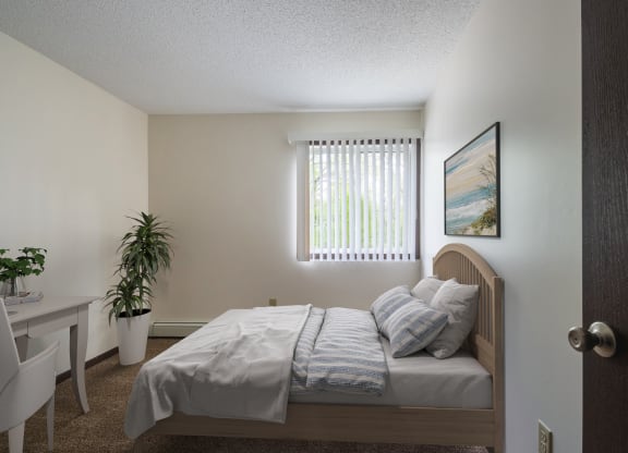 a bedroom with a bed and a desk in a 555 waverly unit