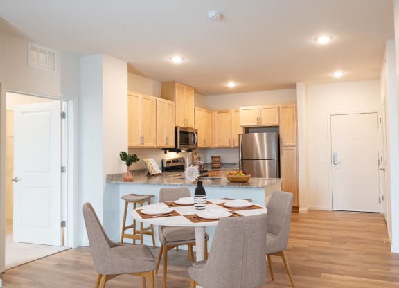 an open kitchen and dining room with a table and chairs