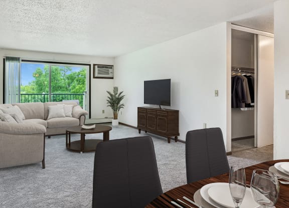 a living room and dining room with a couch and a tv