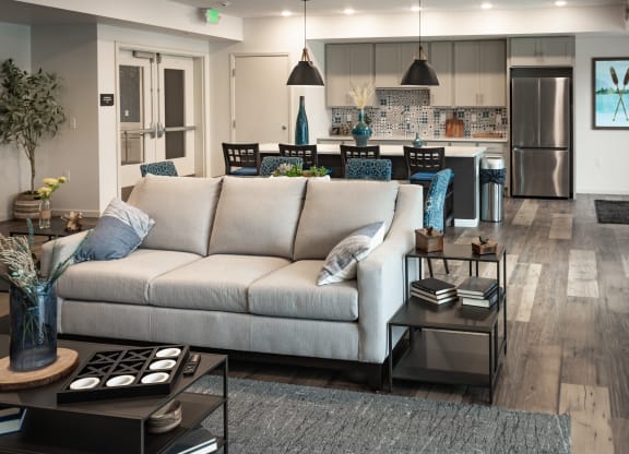 a living room with a couch in front of a kitchen