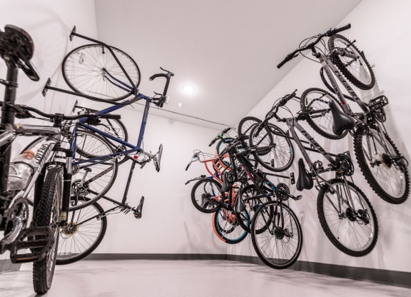 a group of bikes hanging on the wall in a room