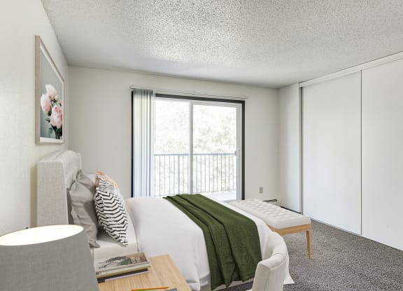 a bedroom with a bed and a chair and a window