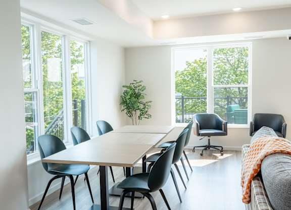 A conference room with a long table and chairs.