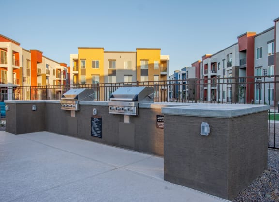 an exterior view of a row of apartment buildings and a sidewalk