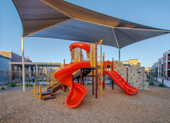 a playground with a slide and a tube