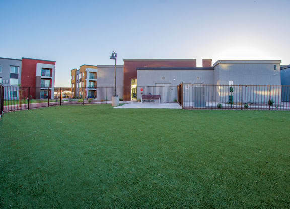 a fenced in yard in front of a building