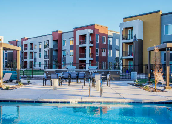 a swimming pool in front of an apartment building