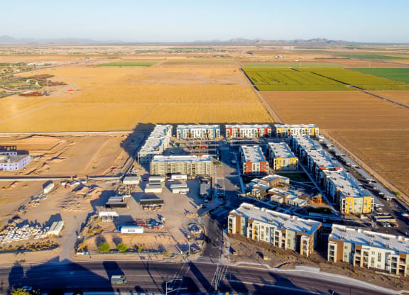 an aerial view of an industrial area with fields and buildings