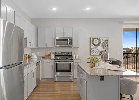 A modern kitchen with stainless steel appliances and white cabinets at Copa Flats Apartments, Maricopa, AZ, 85138