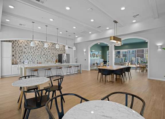A modern dining area with a long table and chairs at Copa Flats Apartments, Arizona, 85138
