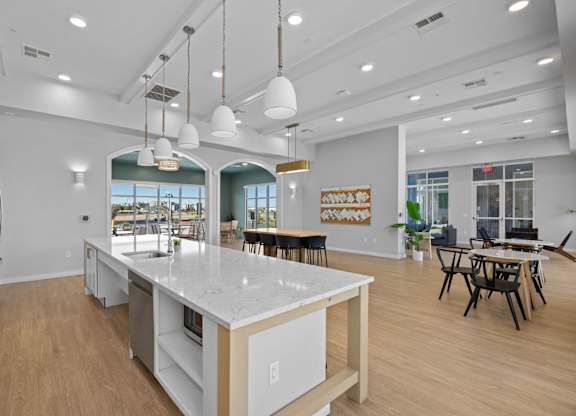 A modern kitchen with a large island and pendant lights at Copa Flats Apartments, Apartments, Maricopa, AZ