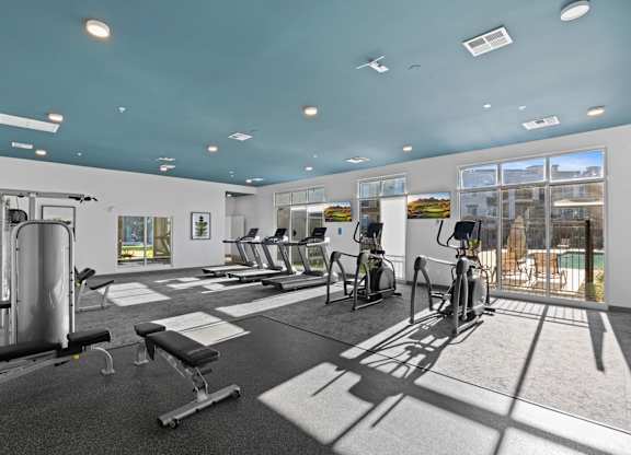 A gym with a variety of equipment including treadmills, weights, and exercise bikes at Copa Flats Apartments, Maricopa, 85138