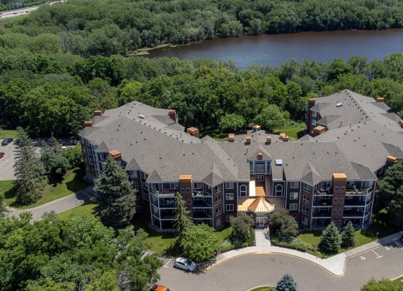 an aerial view of a large building next to a river