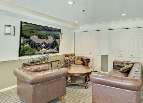 a living room with leather couches and a table