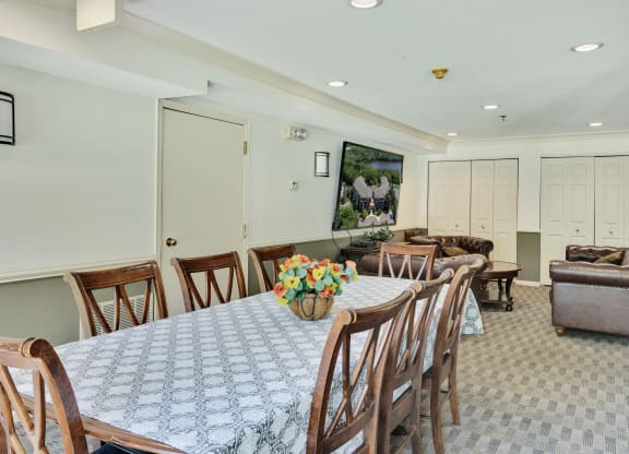a dining room with a table and chairs and a living room with couches