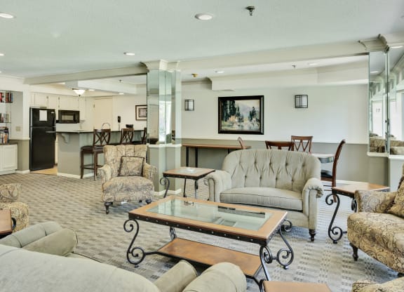 a living room with couches and chairs and a table