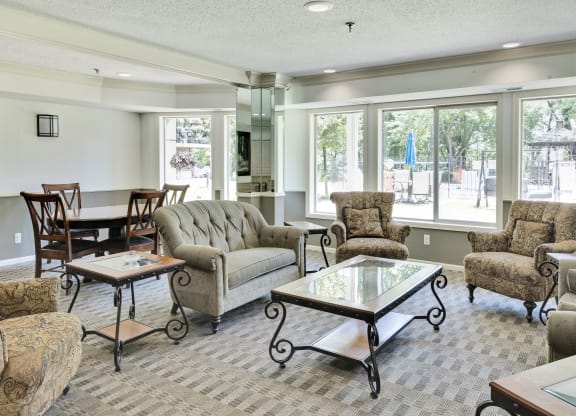 a living room with couches and chairs and a table