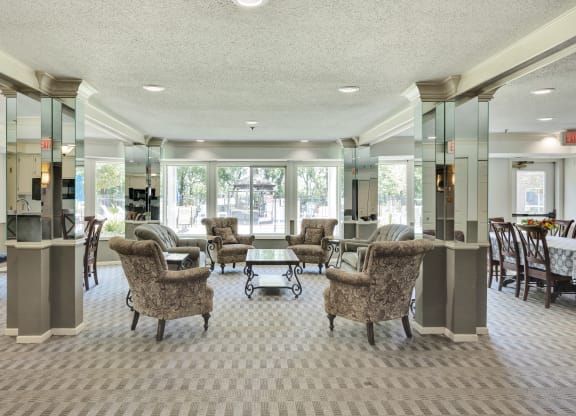 a lobby with couches and chairs and a table