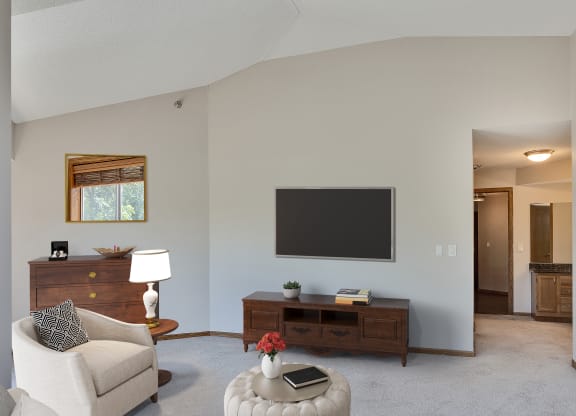 a living room with a couch and a tv on the wall