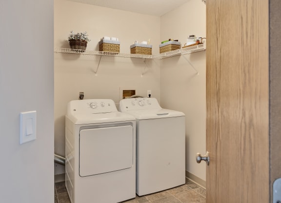 a washer and dryer in a laundry room with a door to the room