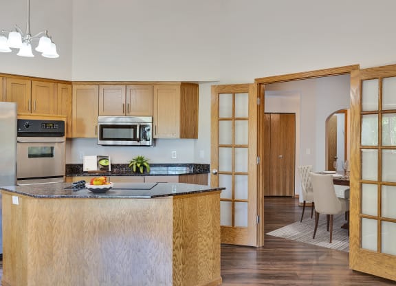a kitchen with an island and a dining room