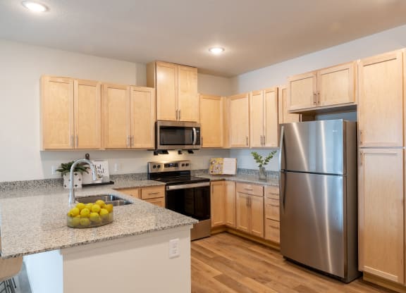 a kitchen with stainless steel appliances and granite counter tops