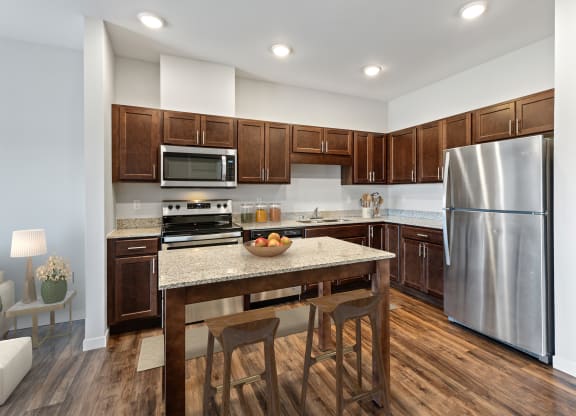 a kitchen with stainless steel appliances and a granite counter top at EastGate Apartments, Rochester, MN