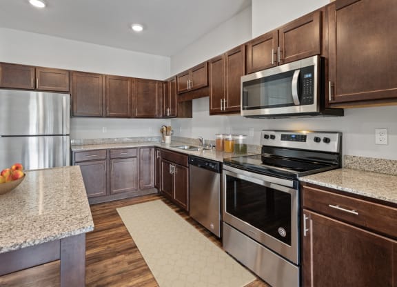 a kitchen with stainless steel appliances and granite counter tops at EastGate Apartments, Rochester, MN