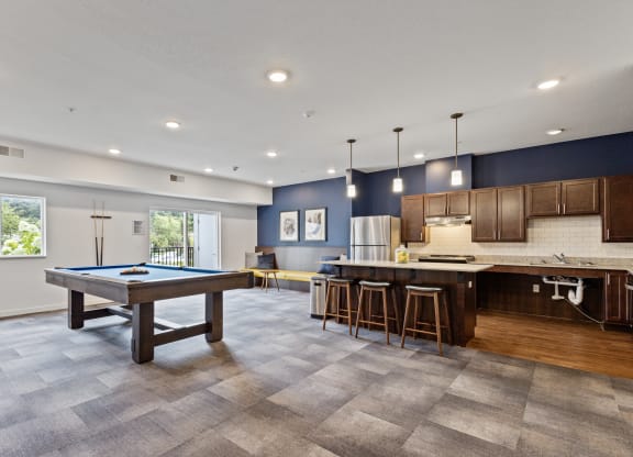 a game room with a pool table and a kitchen at EastGate Apartments, Rochester, MN, 55904