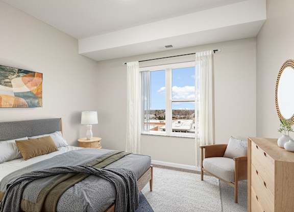 A bedroom with a bed, chair, and a painting on the wall at Decatur Landing Apartment , Brooklyn Park, 55445