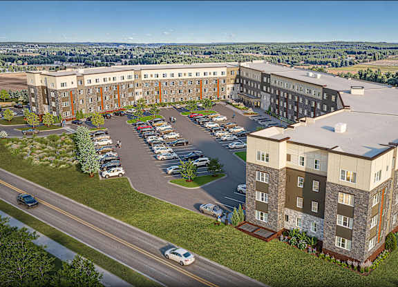 A large building with a parking lot in front of it.