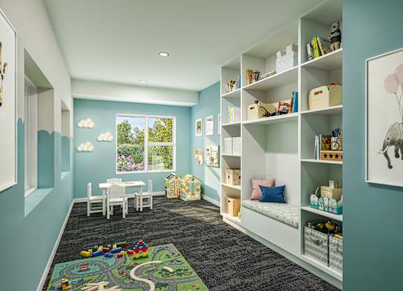 A child's room with a play mat on the floor and a picture of a elephant on the wall.