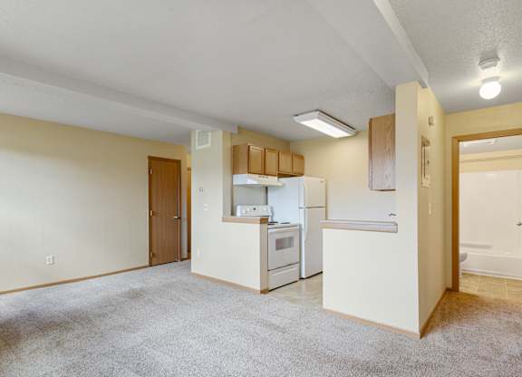 A kitchen with white appliances and a white refrigerator.