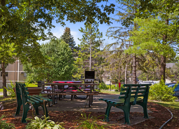 a picnic area with benches and tables in a park at Heritage Hills Apartments, Bloomington, 55437