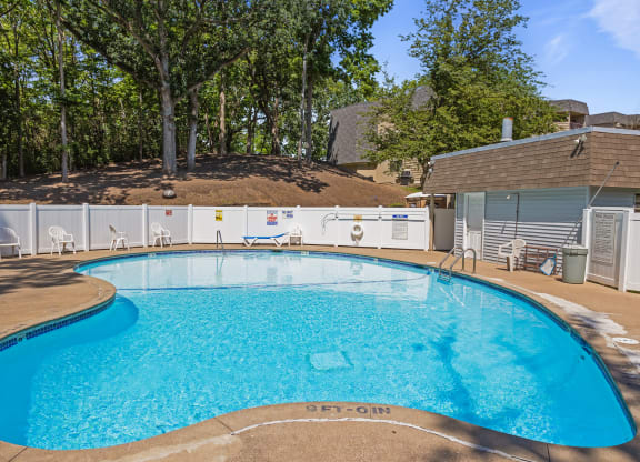 our resort style swimming pool is in front of our house with trees at Heritage Hills Apartments, Bloomington, MN, 55437