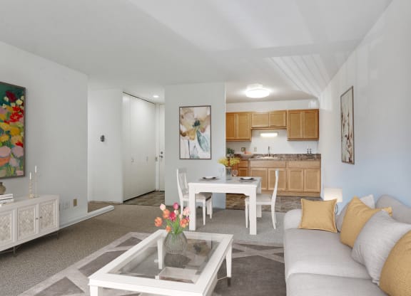 a living room with a couch and a table and a kitchen