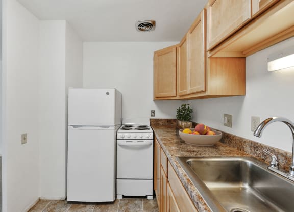a kitchen with a sink and a refrigerator